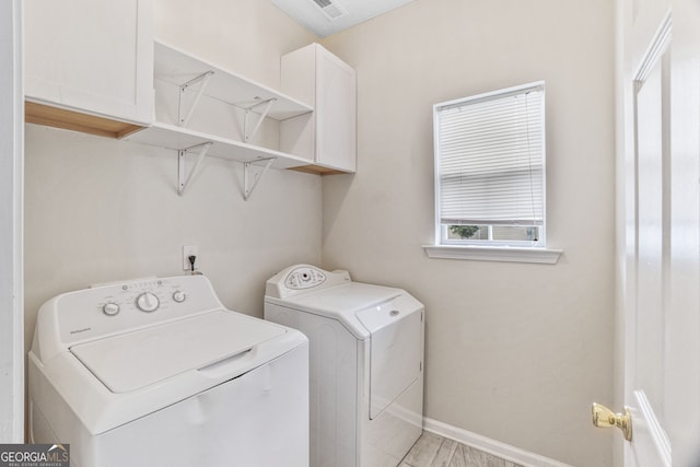 675 Michael Cir, Monroe, GA 30655 - laundry area with washing machine and dryer, cabinet space, and baseboards