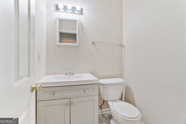 675 Michael Cir, Monroe, GA 30655 - half bath with toilet, vanity, and baseboards