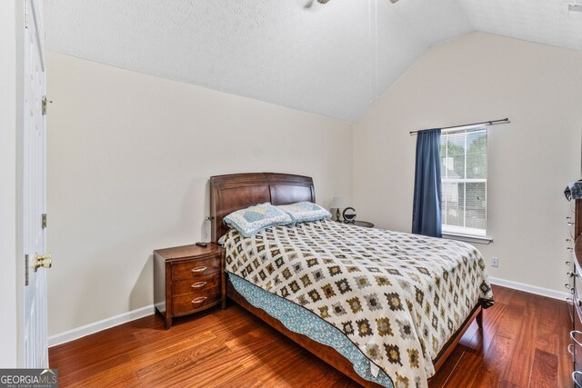 675 Michael Cir, Monroe, GA 30655 - bedroom with lofted ceiling, wood finished floors, and baseboards