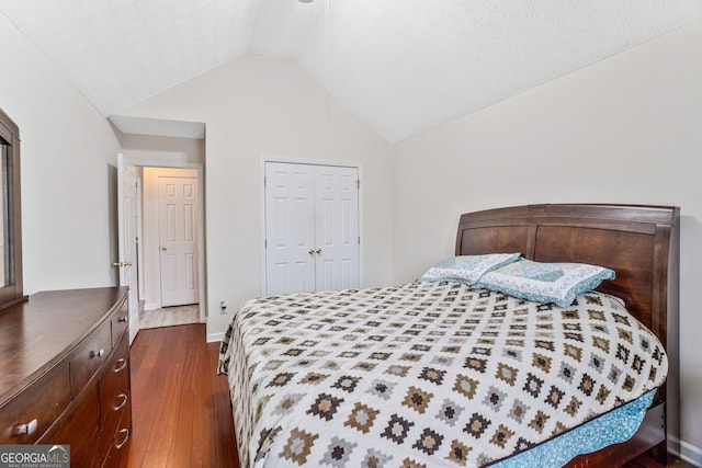 675 Michael Cir, Monroe, GA 30655 - bedroom featuring dark wood finished floors, lofted ceiling, a closet, and baseboards
