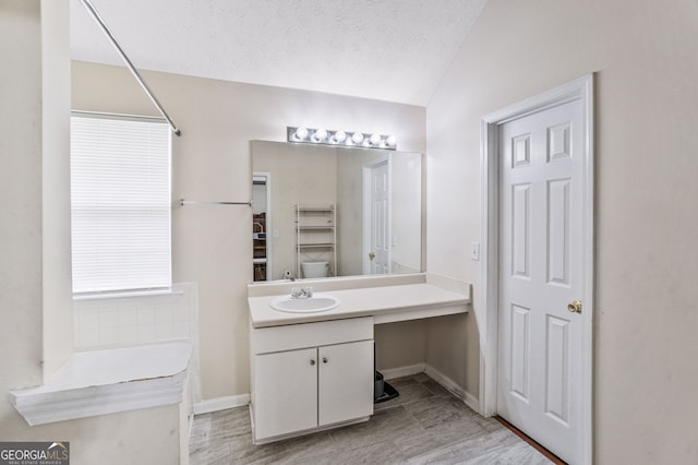 675 Michael Cir, Monroe, GA 30655 - bathroom featuring vanity, lofted ceiling, and baseboards