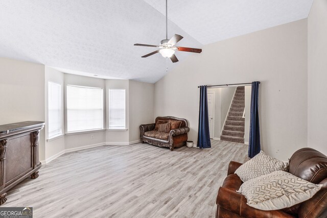 675 Michael Cir, Monroe, GA 30655 - sitting room with lofted ceiling, ceiling fan, light wood-style flooring, stairs, and baseboards