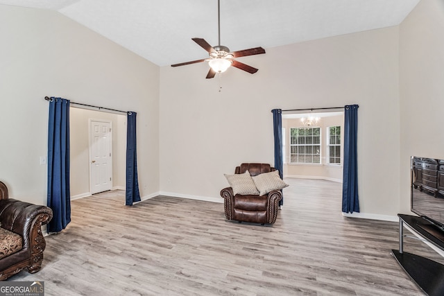 675 Michael Cir, Monroe, GA 30655 - sitting room featuring high vaulted ceiling, wood finished floors, a ceiling fan, a chandelier, and baseboards