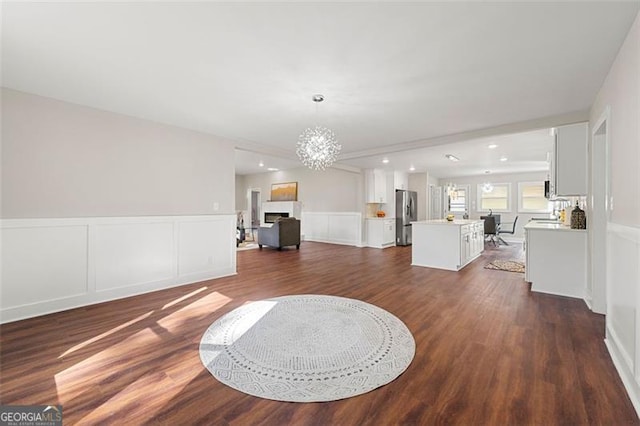 2490 Turtle Ter, Grayson, GA 30017 - living area with dark wood finished floors, wainscoting, a notable chandelier, and a decorative wall