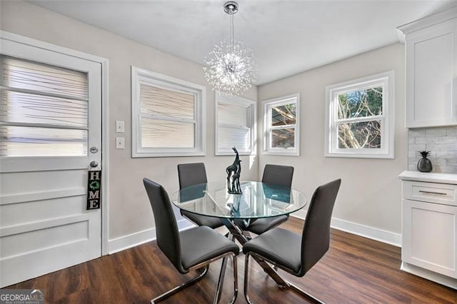 2490 Turtle Ter, Grayson, GA 30017 - dining area with baseboards, a chandelier, and dark wood-style flooring