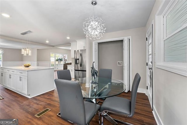 2490 Turtle Ter, Grayson, GA 30017 - dining area with dark wood-type flooring, an inviting chandelier, a healthy amount of sunlight, and visible vents