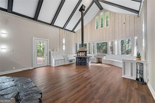 2490 Turtle Ter, Grayson, GA 30017 - living area featuring beam ceiling, a wood stove, wood finished floors, and high vaulted ceiling