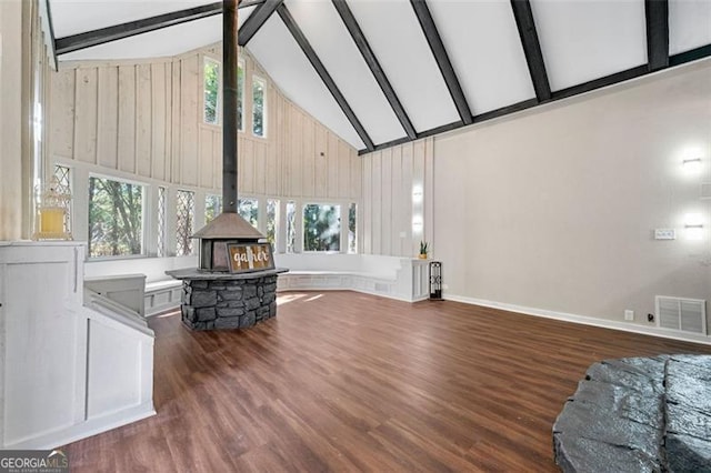 2490 Turtle Ter, Grayson, GA 30017 - living area featuring a healthy amount of sunlight, beamed ceiling, visible vents, a wood stove, and high vaulted ceiling