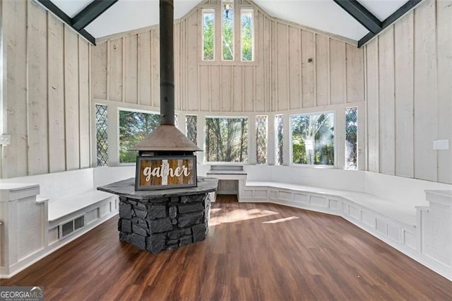 2490 Turtle Ter, Grayson, GA 30017 - interior space with wooden walls, a wood stove, vaulted ceiling with beams, and wood finished floors