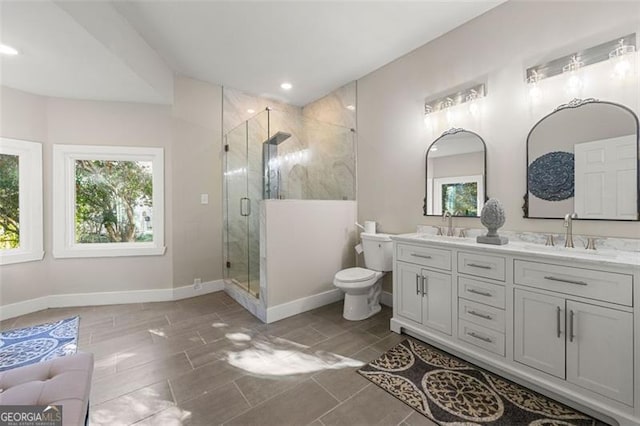 2490 Turtle Ter, Grayson, GA 30017 - bathroom with double vanity, toilet, a stall shower, and a sink