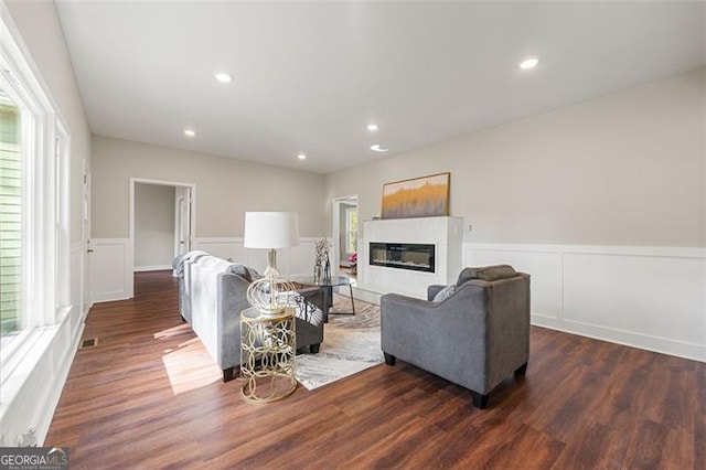 2490 Turtle Ter, Grayson, GA 30017 - living room with wainscoting, a wealth of natural light, wood finished floors, and a glass covered fireplace