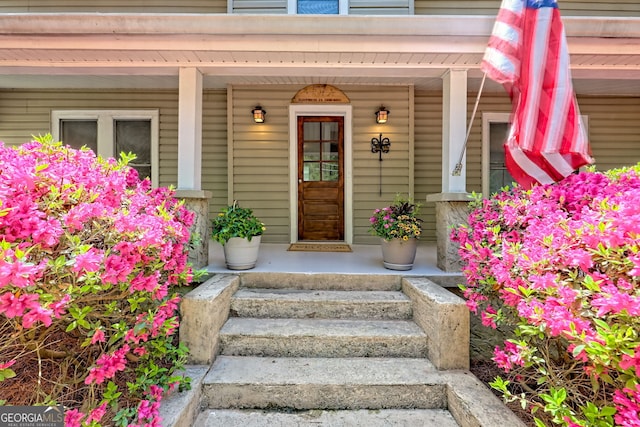 view of exterior entry with a porch