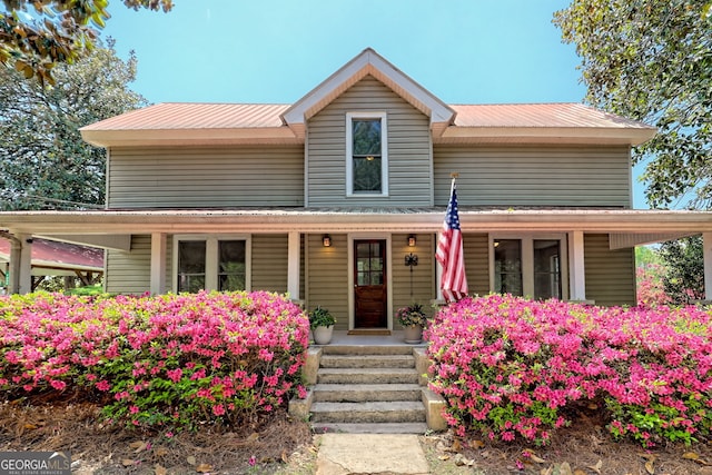 view of front of property with covered porch and metal roof