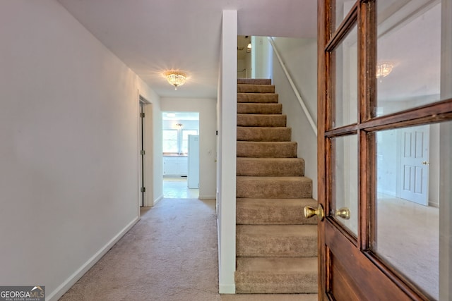 stairway with carpet floors and baseboards