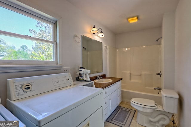 full bath with vanity, toilet, tile patterned floors, washer / dryer, and shower / washtub combination
