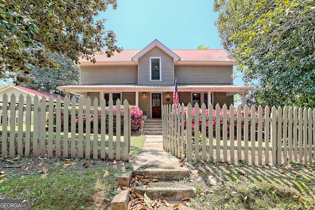 view of front of property with covered porch and a fenced front yard