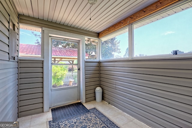 unfurnished sunroom with plenty of natural light