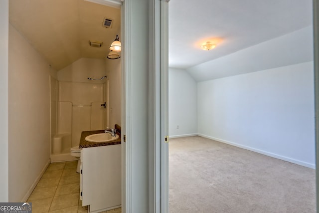 full bath with walk in shower, vaulted ceiling, baseboards, vanity, and toilet