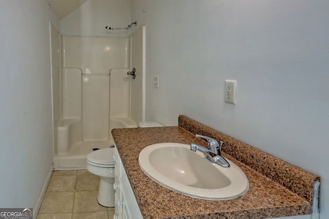 bathroom with vanity, a shower, toilet, baseboards, and tile patterned floors