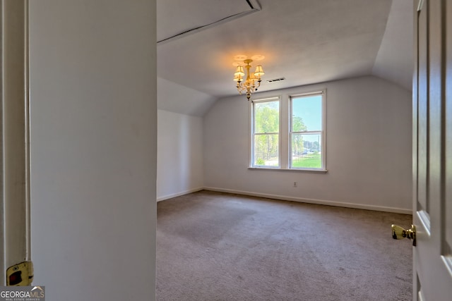 additional living space with an inviting chandelier, carpet floors, baseboards, and vaulted ceiling