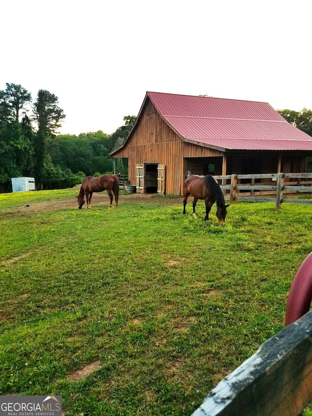 view of stable featuring a rural view