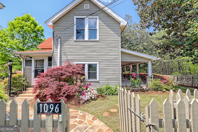 view of side of home featuring fence