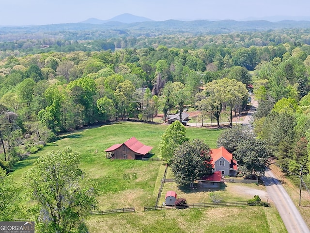 aerial view with a mountain view, a rural view, and a forest view