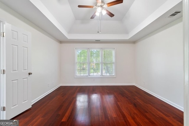 1720 Greystone Trce SE, Conyers, GA 30013 - empty room with a raised ceiling, a ceiling fan, dark wood finished floors, and baseboards