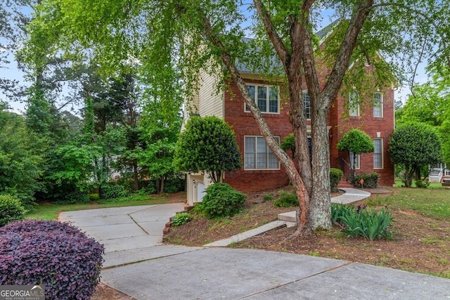 1720 Greystone Trce SE, Conyers, GA 30013 - view of front of house featuring driveway, brick siding, and a garage