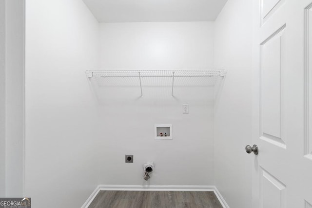 1720 Greystone Trce SE, Conyers, GA 30013 - laundry room with hookup for a washing machine, baseboards, electric dryer hookup, and dark wood-style floors