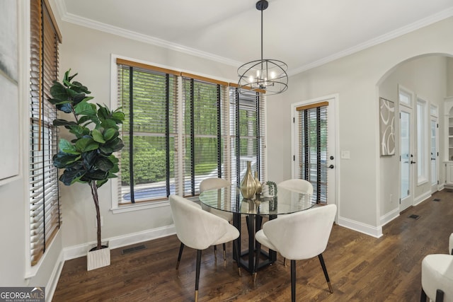 dining space with crown molding, arched walkways, baseboards, and visible vents