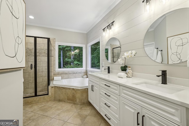 full bathroom with a sink, tile patterned flooring, a garden tub, and a stall shower