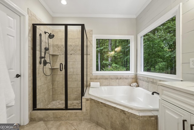 bathroom with tile patterned flooring, ornamental molding, a garden tub, and a stall shower
