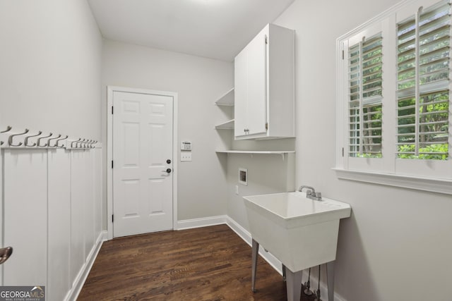 washroom with cabinet space, dark wood-style flooring, washer hookup, and plenty of natural light