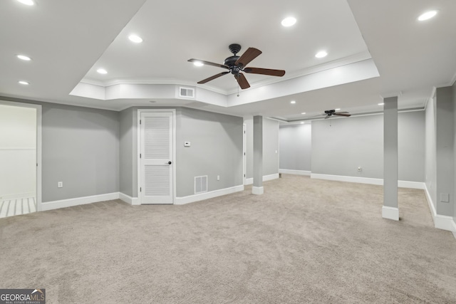 finished basement featuring light carpet, a ceiling fan, recessed lighting, visible vents, and ornamental molding