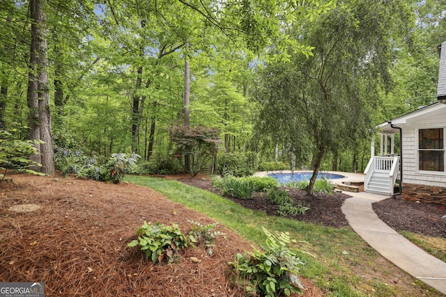 view of yard with an outdoor pool