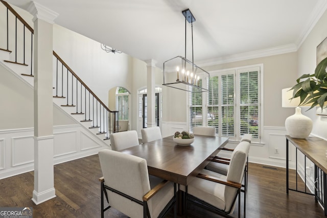 dining room with stairs, a wealth of natural light, and a decorative wall