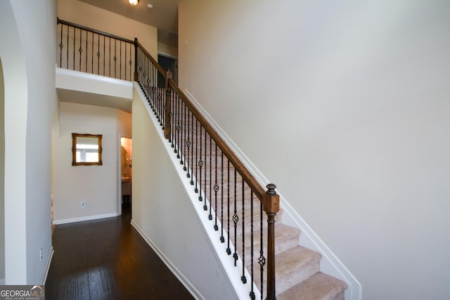 6816 Diamond Dr, Rex, GA 30273 - staircase featuring hardwood / wood-style flooring, a towering ceiling, and baseboards