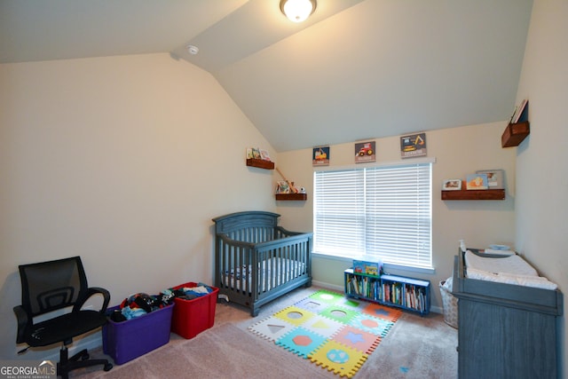 6816 Diamond Dr, Rex, GA 30273 - carpeted bedroom with vaulted ceiling, baseboards, and a nursery area