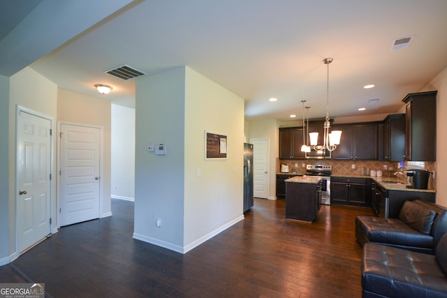 6816 Diamond Dr, Rex, GA 30273 - living room featuring a chandelier, dark wood finished floors, baseboards, and recessed lighting