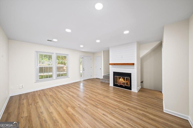 238 Chads Ford Way, Roswell, GA 30076 - unfurnished living room with a large fireplace, wood finished floors, and recessed lighting