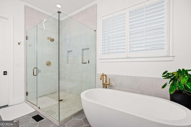 full bathroom featuring a soaking tub, a stall shower, ornamental molding, and tile patterned flooring