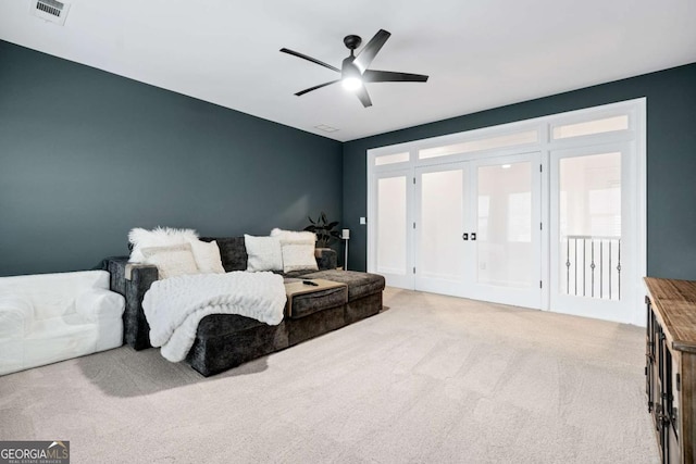 living area with french doors, carpet floors, and ceiling fan