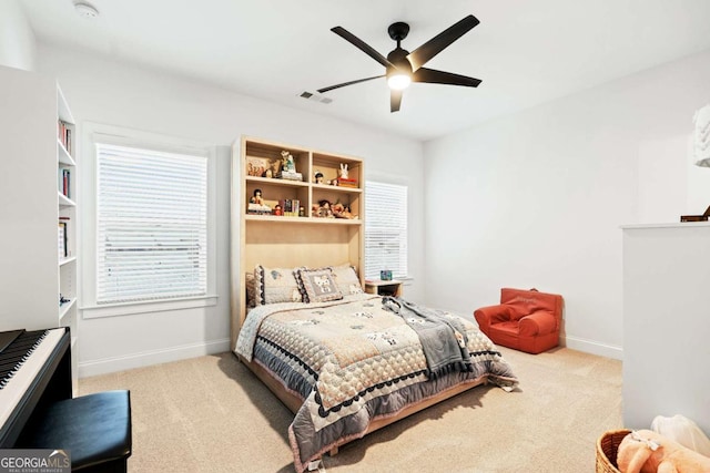 carpeted bedroom featuring baseboards and ceiling fan