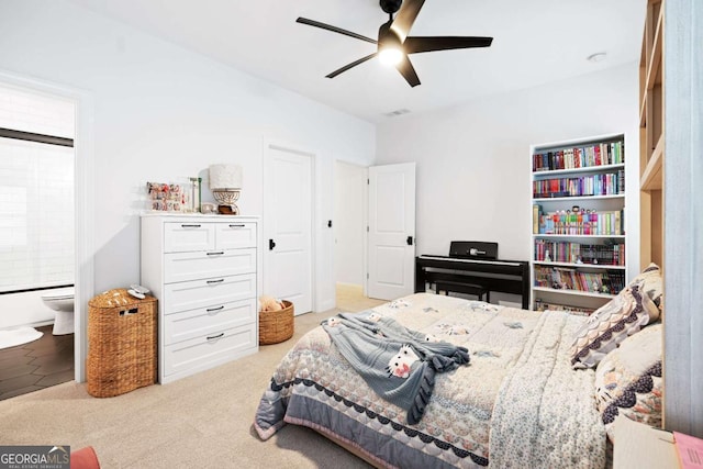 bedroom with connected bathroom, carpet, and ceiling fan