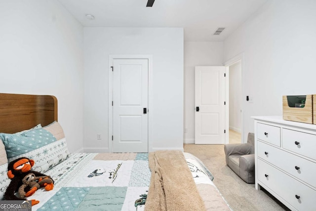 bedroom featuring light colored carpet, baseboards, and a ceiling fan