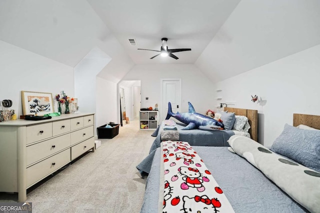 bedroom with light colored carpet, vaulted ceiling, and ceiling fan