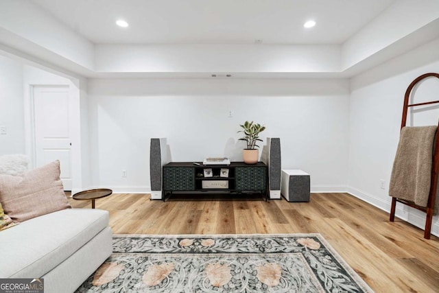 living area with wood finished floors, baseboards, and recessed lighting