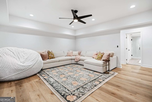 living area featuring wood finished floors, a ceiling fan, baseboards, and recessed lighting