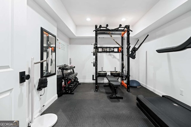 workout area with baseboards and recessed lighting